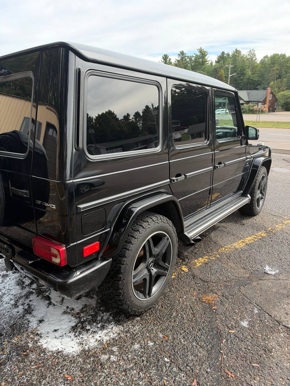 Freshly washed black G-Wagon, rear three-quarter view, close up